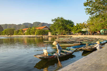 Many wooden Row Boats or sampan (old Chinese rowing boats) on the Tam Coc River is it well knows Halong Bay on Land. Tam coc, Ninh Binh, Vietnamのeditorial素材
