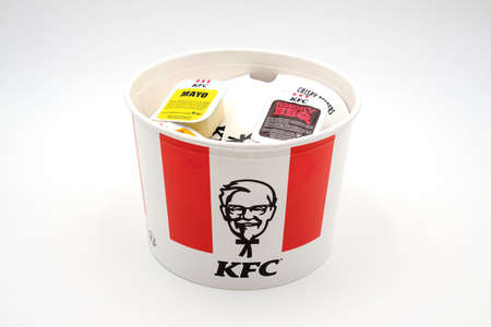 Chicken basket from Kentucky fried chicken, KFC, with sauces on top, namely smoky BBQ and mayo or mayonaise featuring the official KFC logo with colonel harland sanders.のeditorial素材