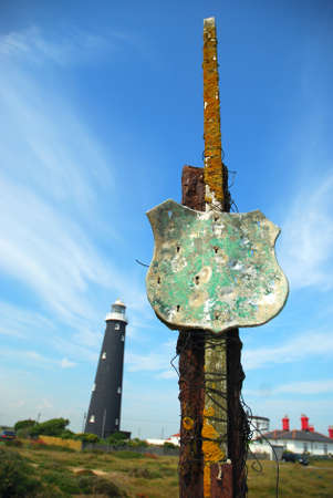 Rusty post and Old Dungeness Lighthouse の写真素材