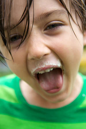 Cute young boy screaming with joyの写真素材