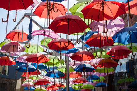 Colourful umbrellas suspended in the airの写真素材