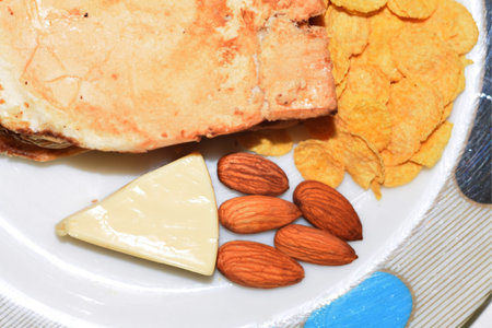 Asian Food Plate. Bread, Cereal, Cheese, Almonds, Corn Flakes, Breakfast Servingの写真素材