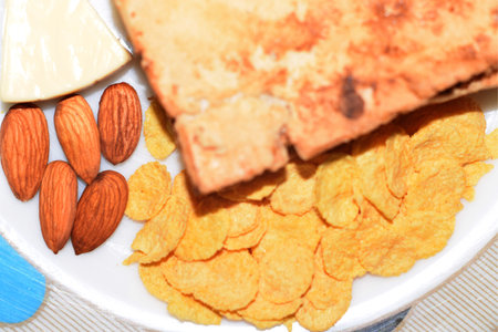 Asian Food Plate. Bread, Cereal, Cheese, Almonds, Corn Flakes, Breakfast Servingの写真素材