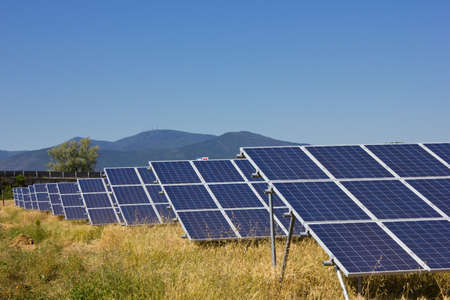Solar power plant against a mountain landscapeの写真素材