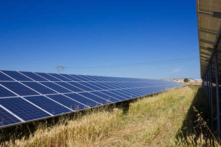 Solar power plant against a deep blue skyの写真素材