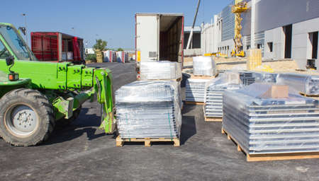 Forklift loading pallets in warehouseの写真素材