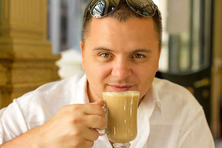 man drinking coffee at the coffee barの写真素材