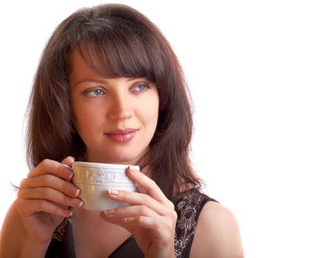 Young beautiful woman drinking teaの写真素材