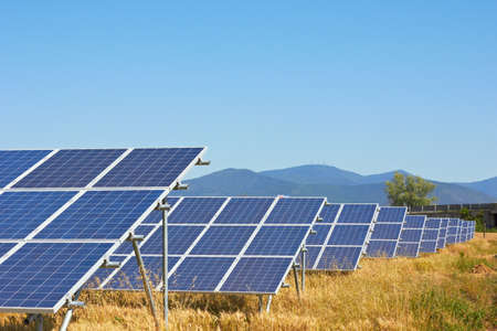 Solar power plant against a mountain landscapeの写真素材