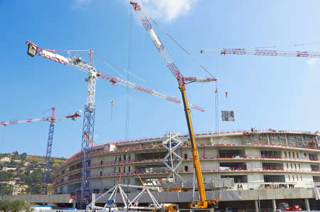 Construction of modern stadium, tower cranesの写真素材