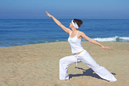 Yoga on the beach in summer day の写真素材