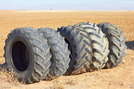 Car wheels row against fieldの写真素材