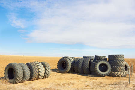 Car wheels row against fieldの写真素材