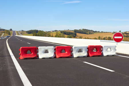 Fence on the highway closed and diversion signsの写真素材