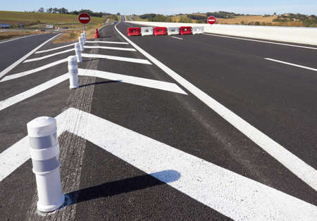 Fence on the highway, closed and diversion signsの写真素材