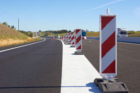 A row of  traffic signs set on the road の写真素材