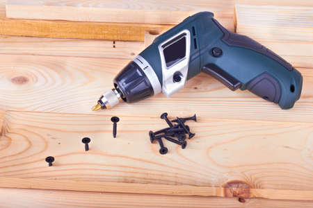 screws and a screwdriver on a boards