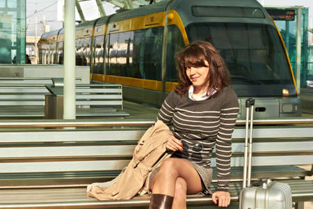 Girl at the railway station against a trainの写真素材
