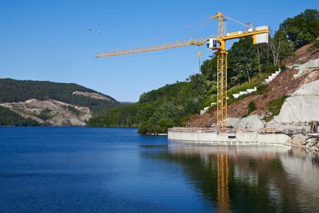 construction crane over the riverの写真素材