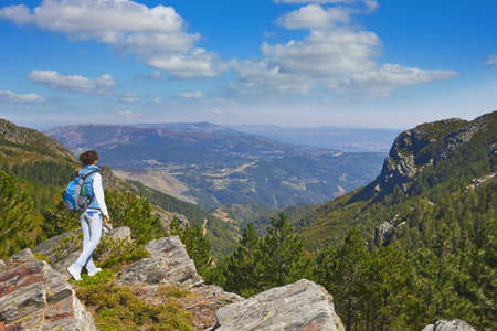 enjoying view from top of a mountain on a rock in the National Park in Portugal