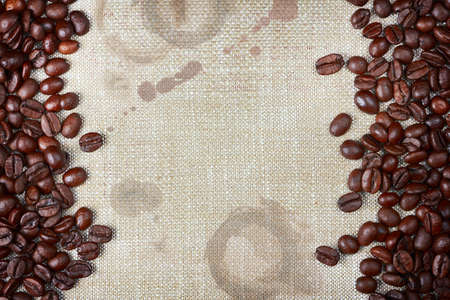 coffee beans and burlap with coffee stains and rough edgesの写真素材