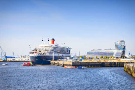 HAMBURG, GERMANY - SEPTEMBER 28, 2016: Queen Mary 2 cruise ship in the Port of Hamburg and the Elbe river on September 28, 2016のeditorial素材