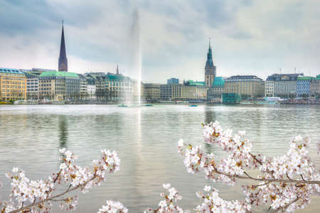 Lake with a fountain and a ships, center of Hamburg in springtime, Germanyのeditorial素材