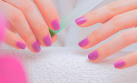 Female hands making nail manicureの写真素材