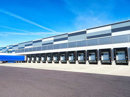 Industrial building and warehouse with trucksの写真素材
