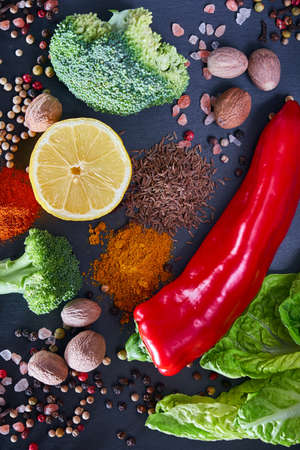 Spices, vegetables and herbs on a stone background. View from aboveの写真素材