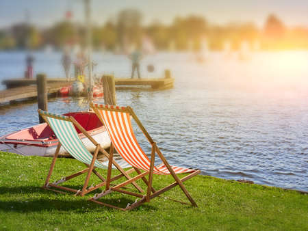 Chairs on the sandy beach near river. Summer holiday and vacationの写真素材