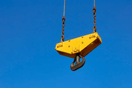 Crane hook on steel cables. Blue sky on backgroundの写真素材