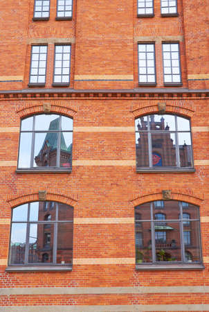 Old brick house windows in Hamburgの写真素材
