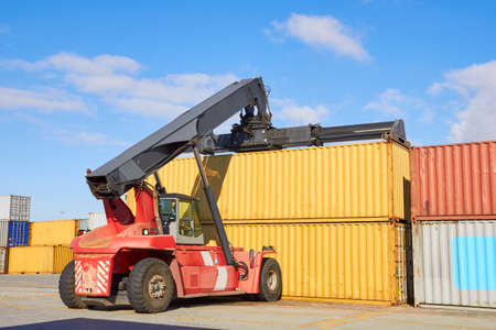 Toplifter working with cargo container in portの写真素材