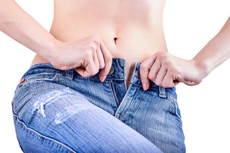 Overweight problem. Woman cannot button up her jeans