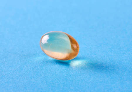 Fish oil omega 3 gel capsule on blue backgroundの写真素材
