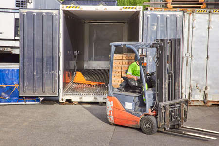 Worker on forklift loading carの写真素材