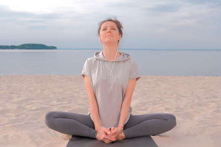 Beautiful caucasian Woman sitting in lotus yoga pose