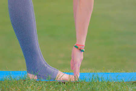 Female yoga doing sport stretching exercises on mat