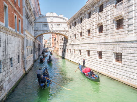 Traditional gondolas floating on canal in Venice.の写真素材