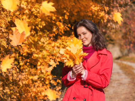 Young beautiful girl enjoying the autumn dayの写真素材