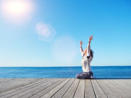 Woman with raised hands up to the sun. Freedom concept.の写真素材