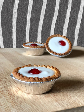 Bakewelll tarts in front of zebra striped wall