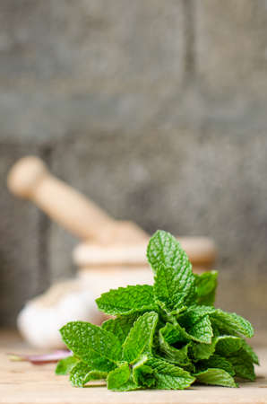 Rustic still life of aromatic herbs with a wooden mortarの写真素材