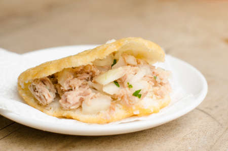Arepa stuffed with tuna, onions and parsley, typical Latin American food made with cornmeal.の写真素材