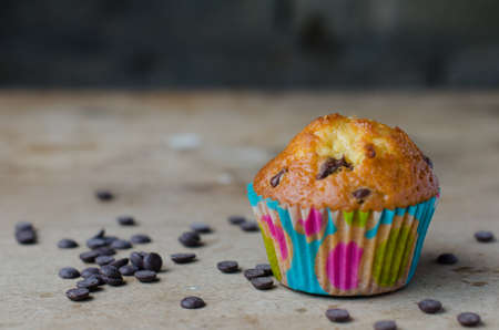 Homemade chocolate chip cupcake, rustic background.の写真素材