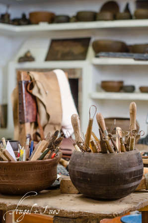 Workshop of a craftsman pottery and tools, decorating a vessel.の写真素材