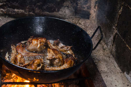 Frying rabbit meat over hot coals, rustic background.の写真素材