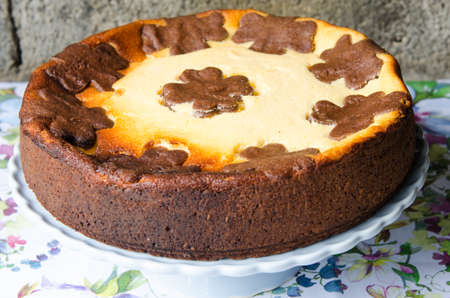 Cheesecake with chocolate and vanilla. Rustic background.