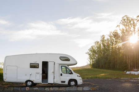 Holiday trip in motorhome. Camper Camping at meadow in Galicia, Spain at sunrise.
